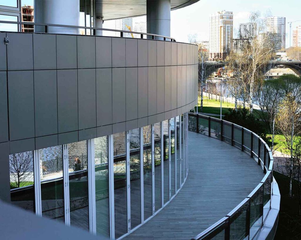 building with rounded aluminum facade and balconies